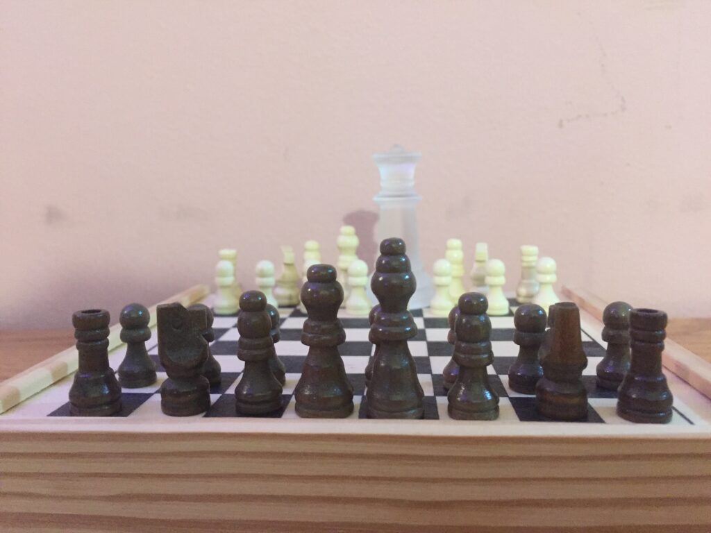 A chess board with a much larger Queen on the opposing side. 
